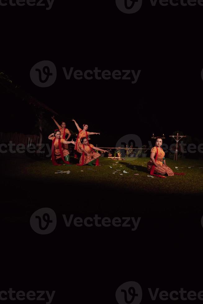 Portrait of Balinese dancer while dancing on the stage with traditional costume and makeup during the competition photo