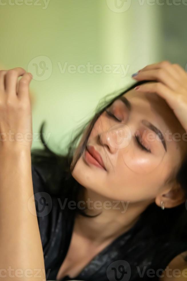 Indonesian Women being headache after swallowing a medicine for her ill