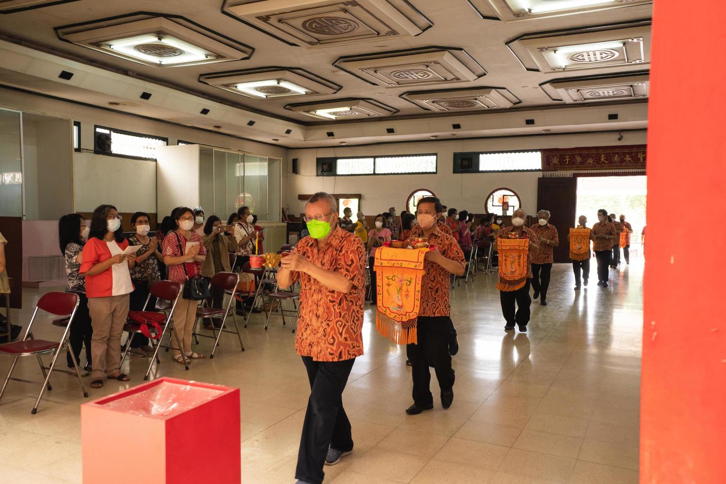 Bandung City, Indonesia, 2022 - Buddhist society walking together for praying at the altar with the monks inside the buddha temple photo