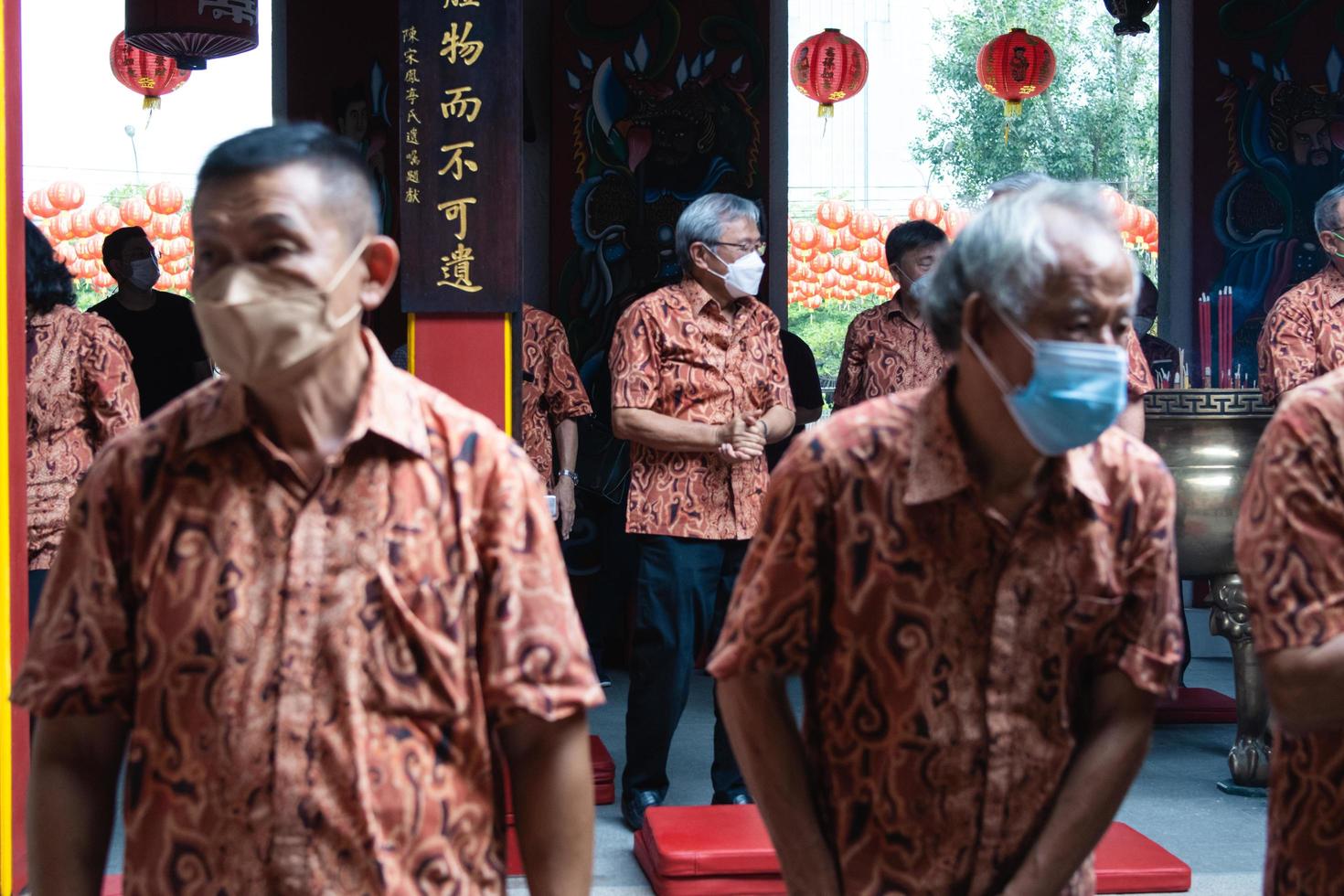 Bandung City, Indonesia, 2022 - Buddhist society walking together for praying at the altar with the monks inside the buddha temple photo