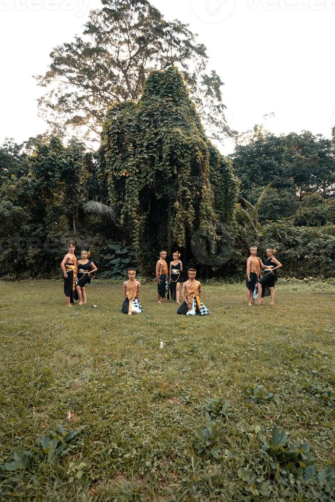 A Group of Thailand people pose in a golden costume while performing inside the village photo