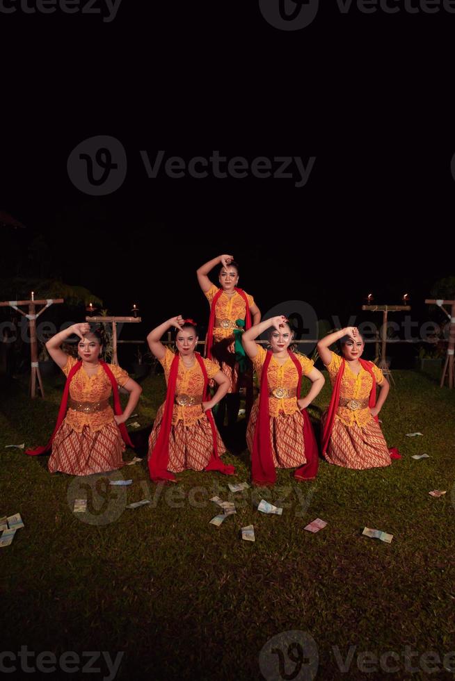 Asian dancers take pose with dance movements while performing the traditional dance in the competition photo