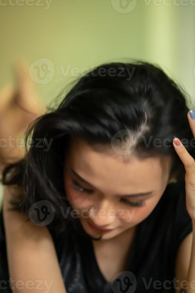 Unfocused and blurry faces of Asian women wearing a black dress photo