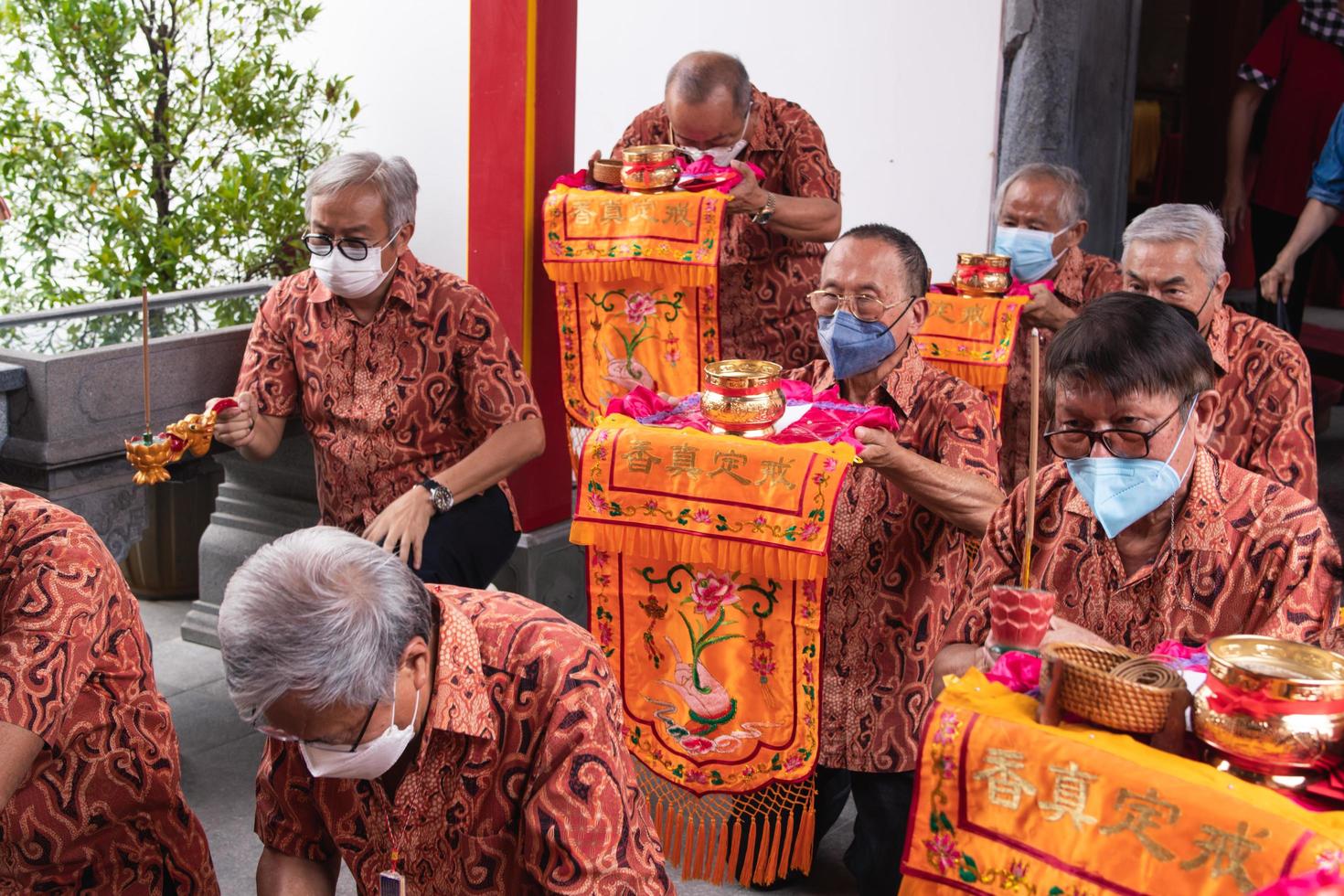 Bandung City, Indonesia, 2022 -The tourist bring the offerings for the monks while praying to the god together at the Buddha temple photo