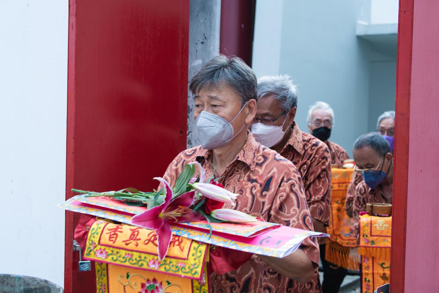 Bandung City, Indonesia, 2022 - Buddhist society walking together for praying at the altar with the monks inside the buddha temple photo