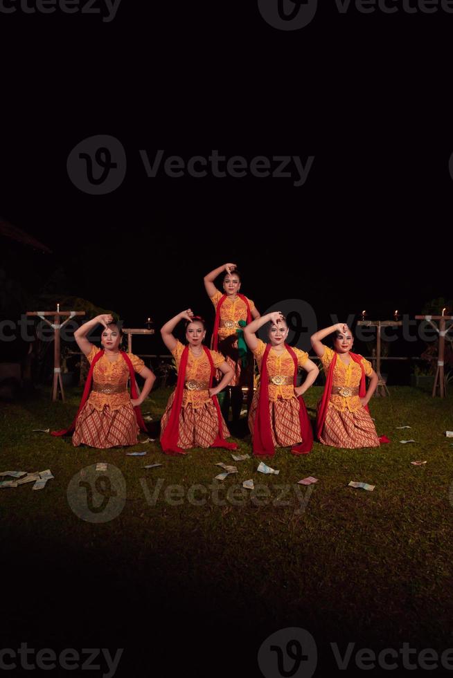 Asian dancers take pose with dance movements while performing the traditional dance in the competition photo