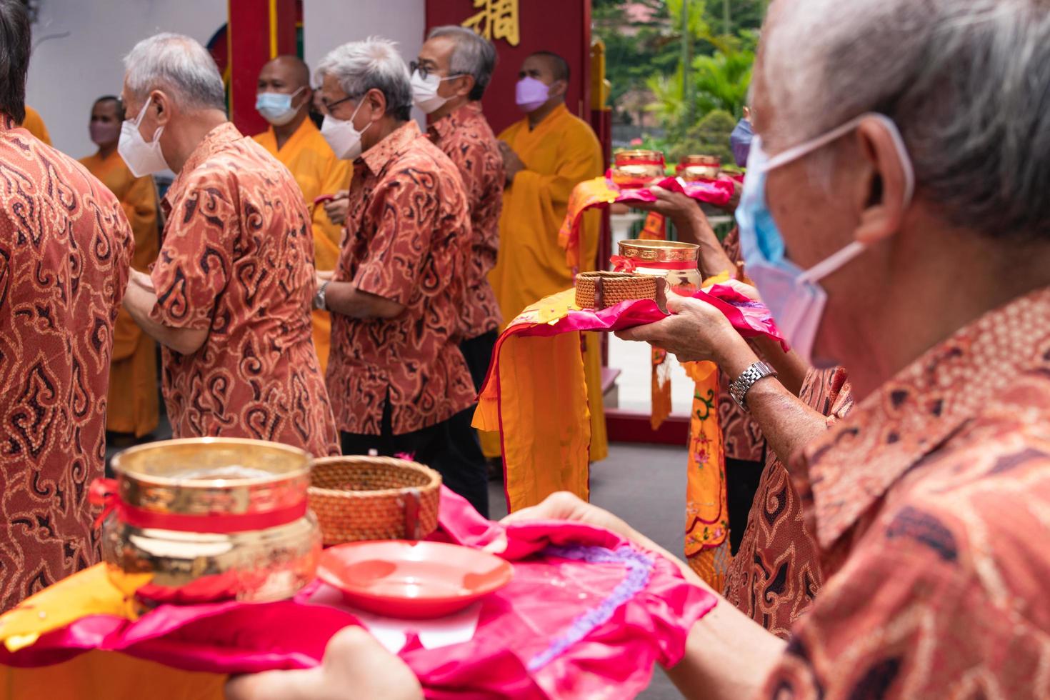 Bandung City, Indonesia, 2022 - The tourist bring the offerings for the monks while praying to the god together at the Buddha temple photo