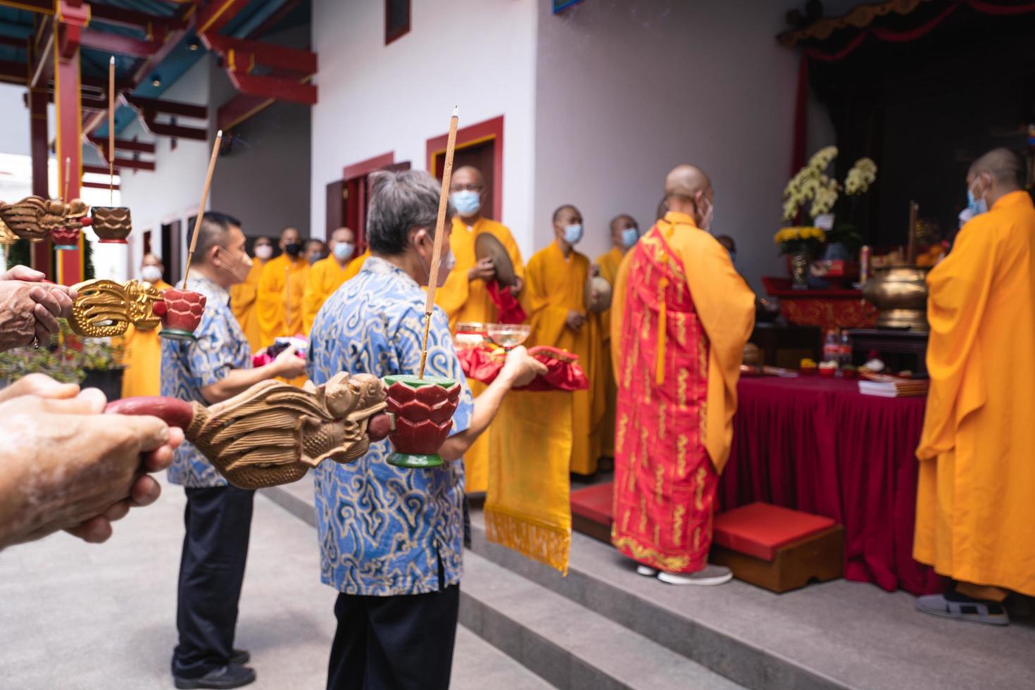 Bandung City, Indonesia, 2022 - Buddhist community praying together with the monks in front of the altar photo