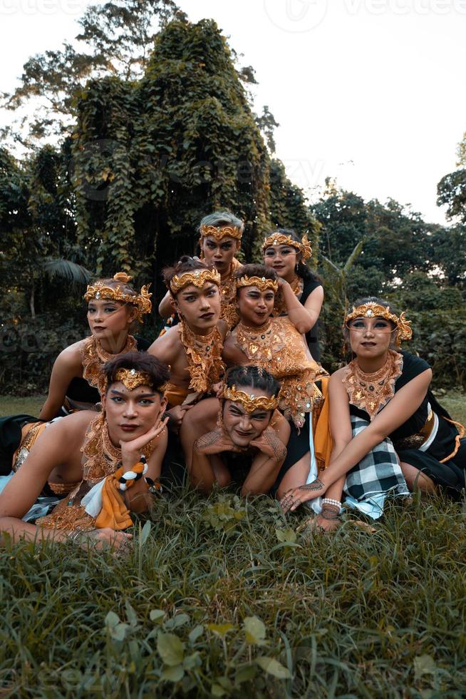 Balinese people have fun together with their friends in golden costumes after the dance performance photo