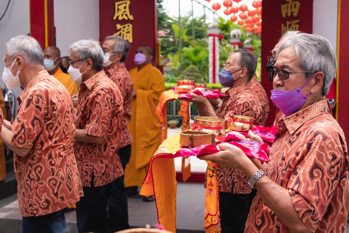 Bandung City, Indonesia, 2022 - The tourist bring the offerings for the monks while praying to the god together at the Buddha temple photo