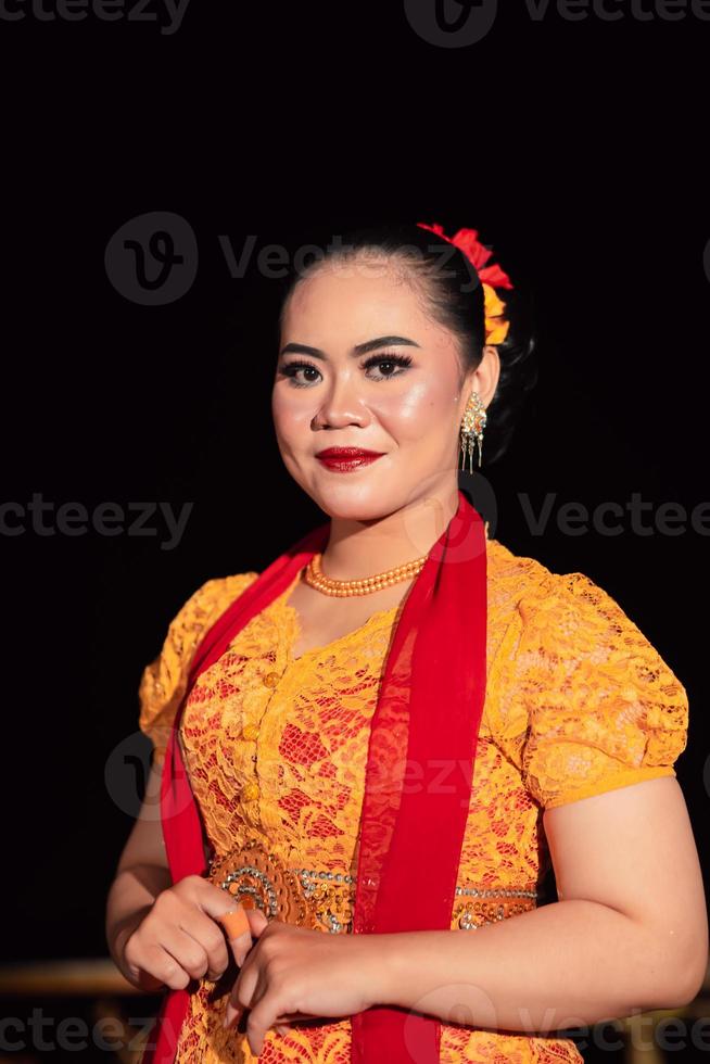 Cute Indonesian woman with red lips and a red scarf wearing a traditional Sundanese dress called kebaya photo