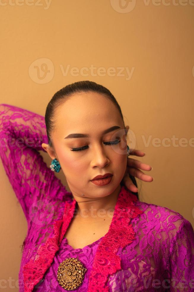 Asian woman touches her head while posing with makeup photo