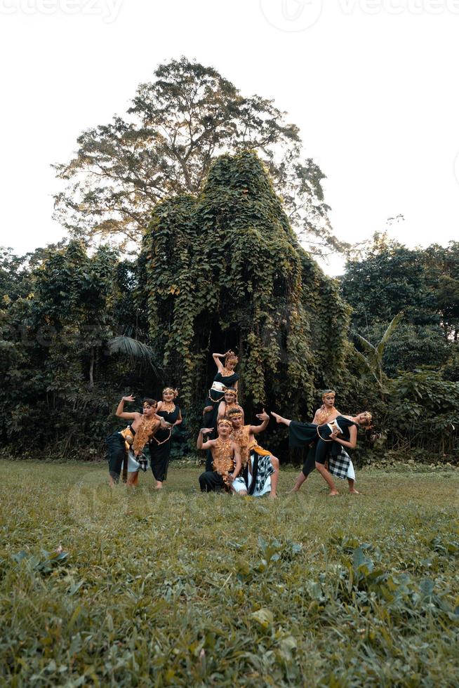 Indonesian dancers pose with their bodies while wearing a traditional golden costume from Javanese photo