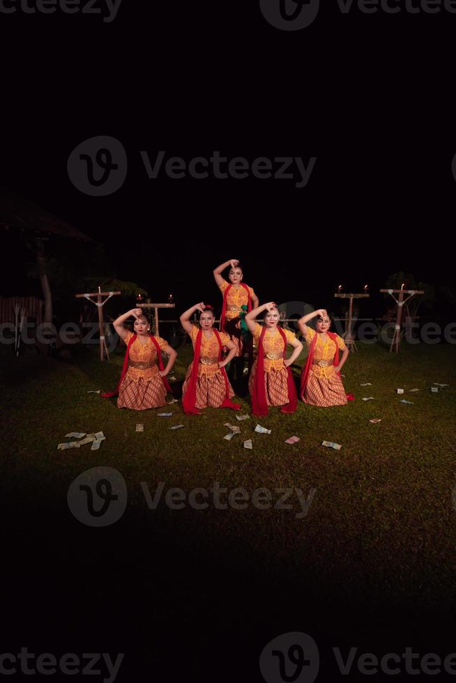 Asian dancers take pose with dance movements while performing the traditional dance in the competition photo