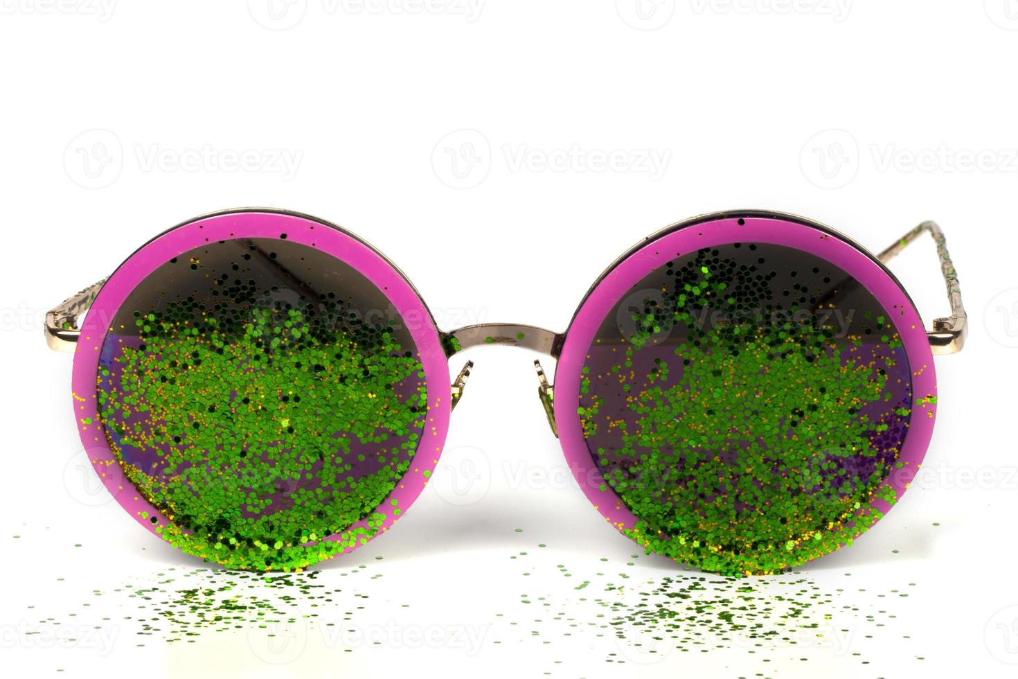 Glamorous sunglasses with green sparkles on a white background. photo