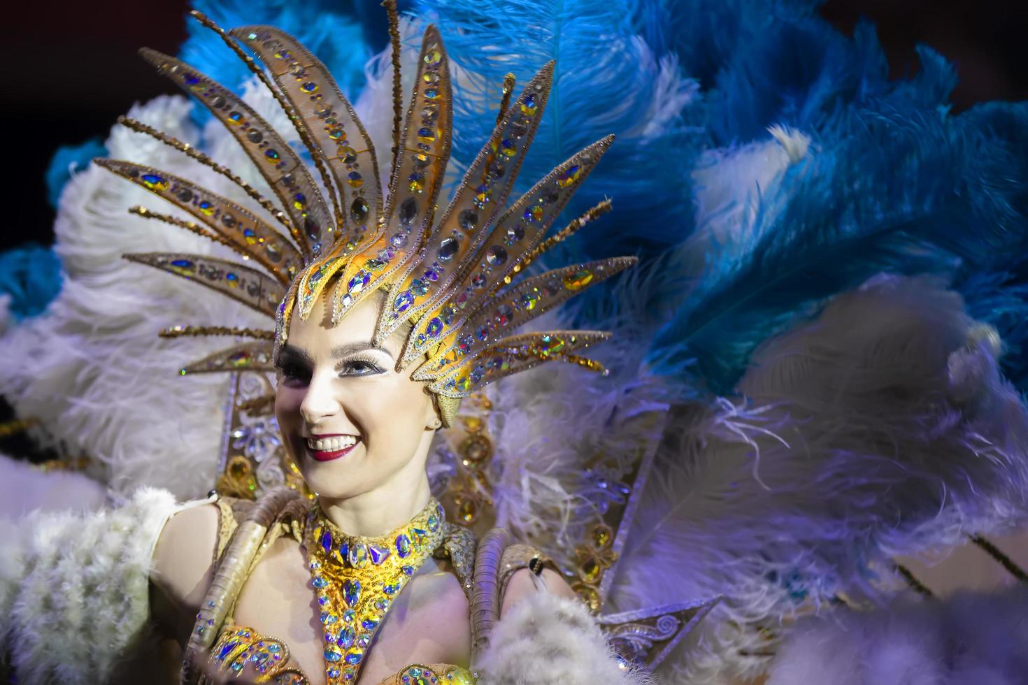 Beautiful girl in feathers at the Brazilian carnival. photo