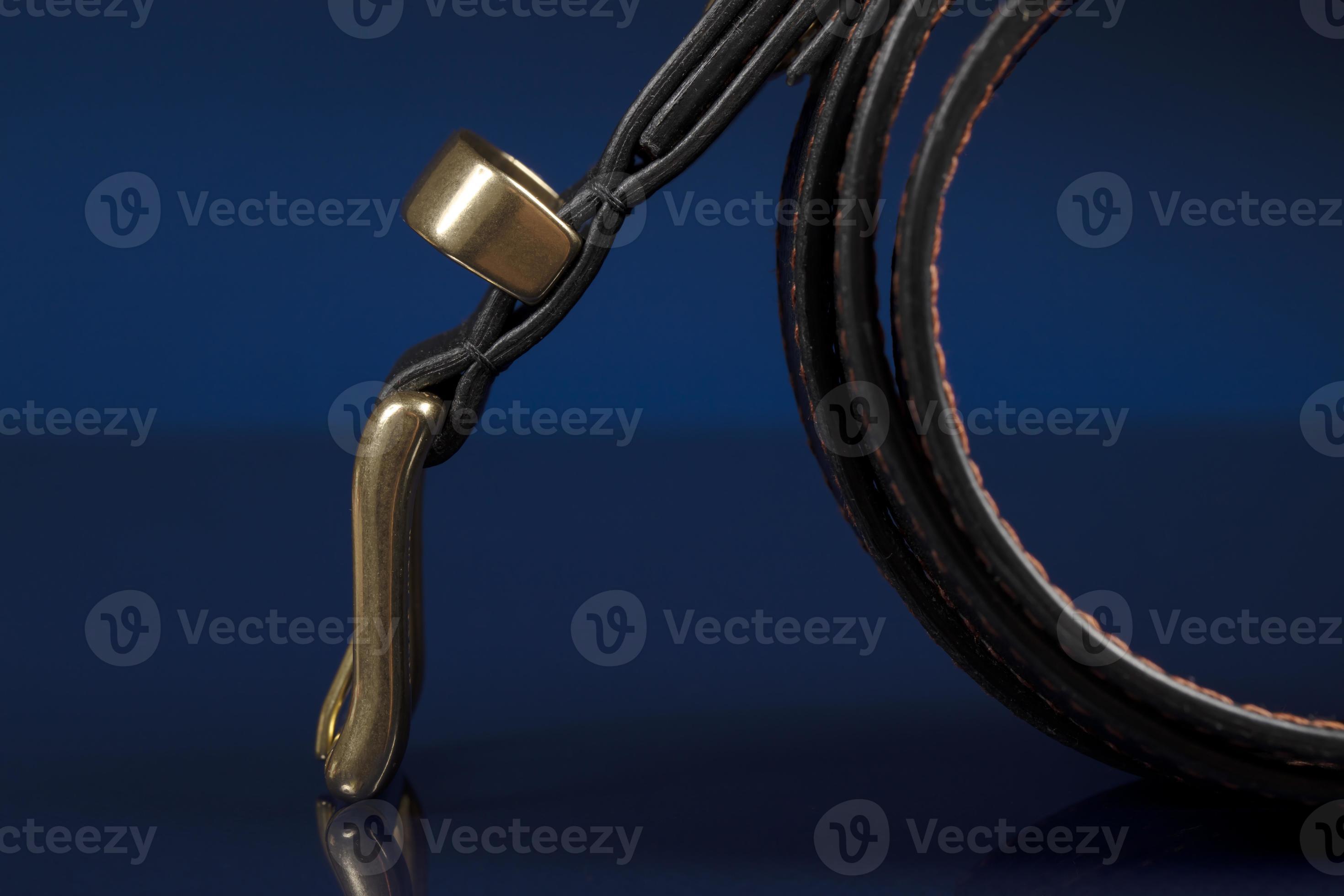 Black leather belt on a dark blue background. 19089380 Stock Photo at