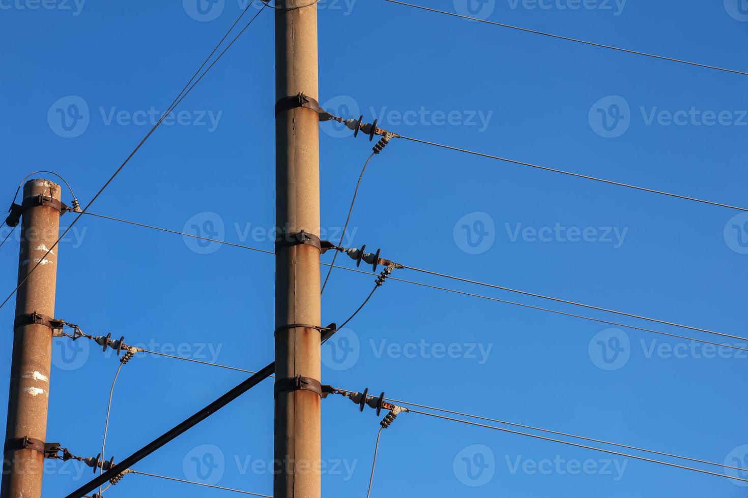 Electric pole with a linear wire against the blue sky close-up. Power electric pole. photo