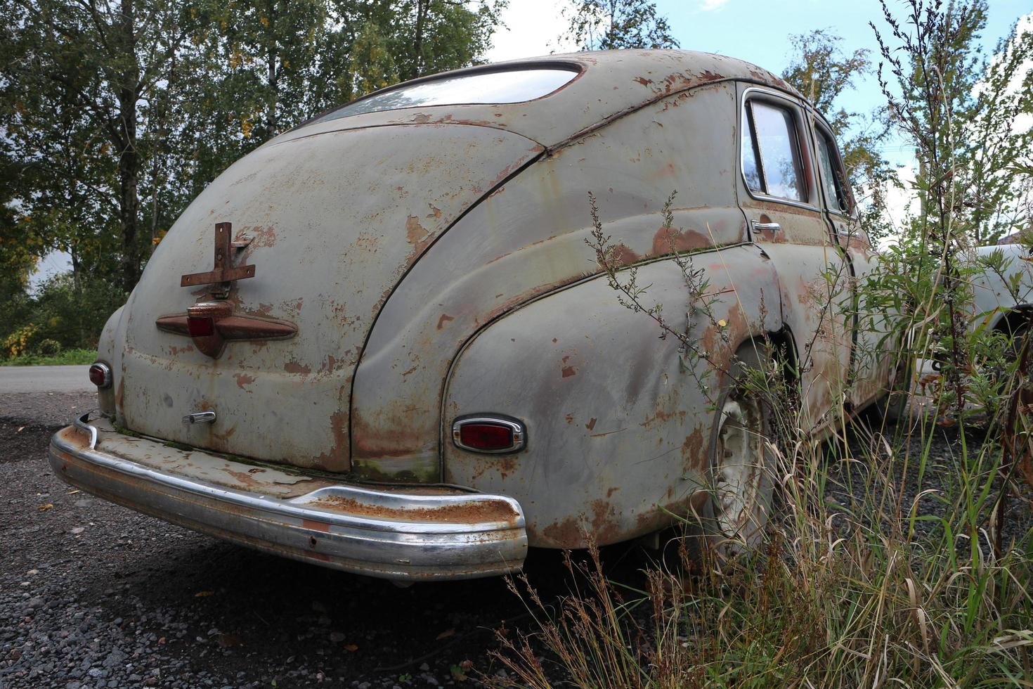 Abandoned vintage car rear view, low angle photo