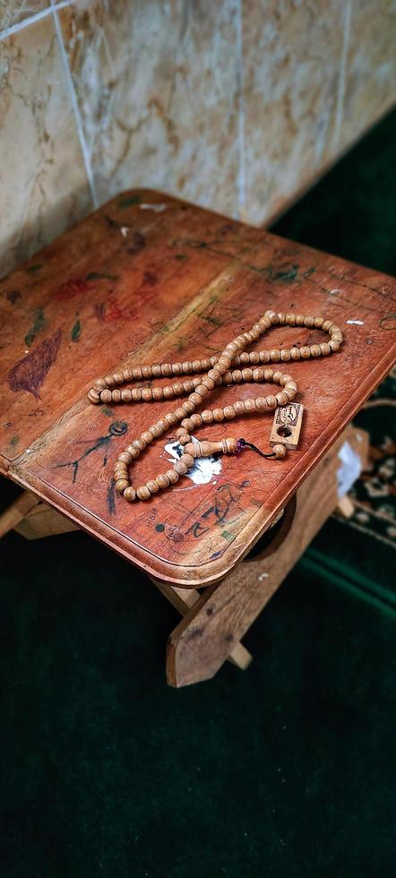 Tasbih on a small table that is usually used for Muslims to read the Al Quran photo