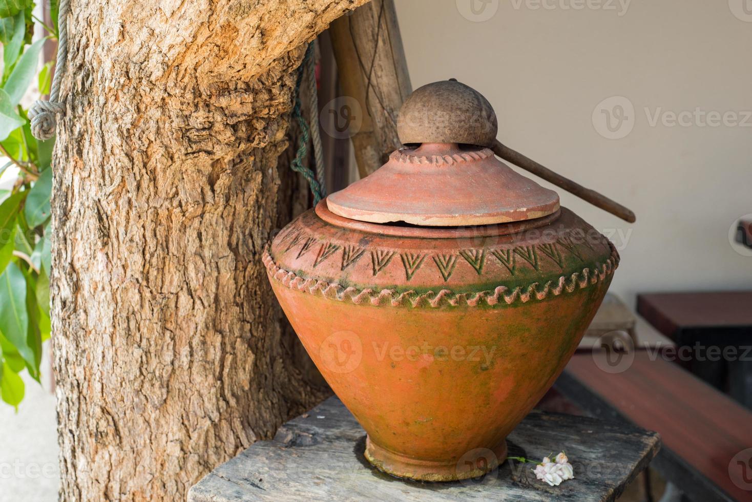 Eastern water jar in the garden photo