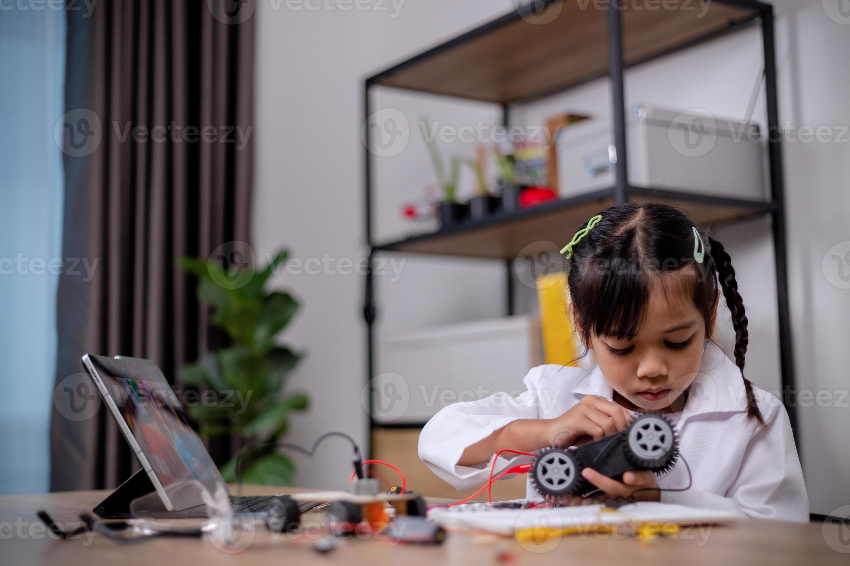 Asian students learn at home by coding robot cars and electronic board ...