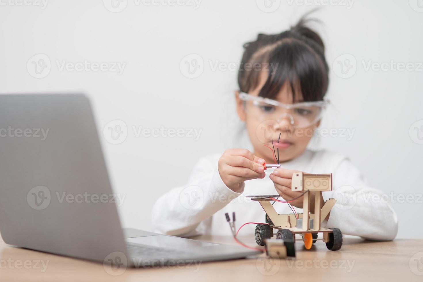Asia students learn at home in coding robot cars and electronic board cables in STEM, STEAM, mathematics engineering science technology computer code in robotics for kids concept. photo