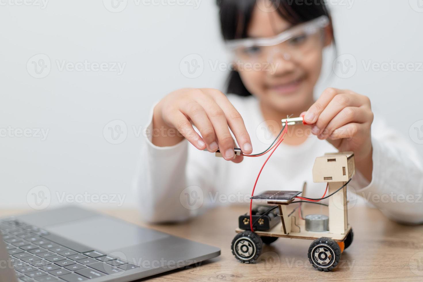 Asia students learn at home in coding robot cars and electronic board cables in STEM, STEAM, mathematics engineering science technology computer code in robotics for kids concept. photo