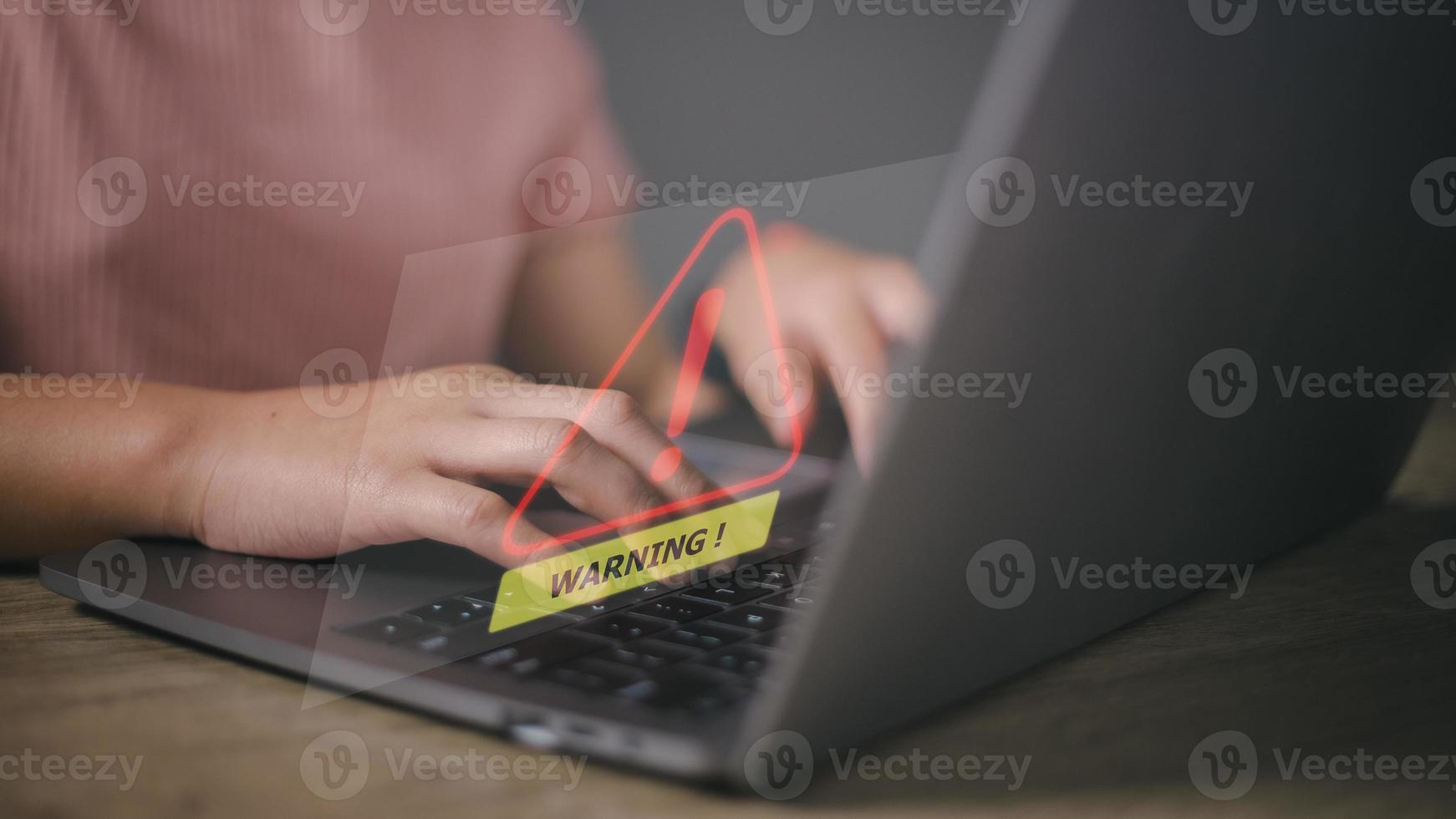 developer using computer laptop with triangle caution warning sign for notification error and maintenance concept. photo