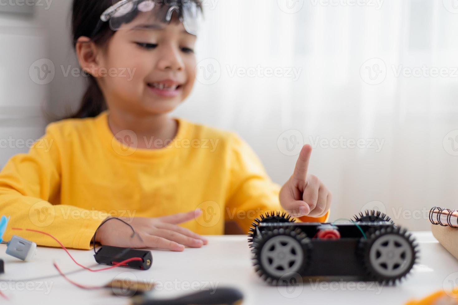Asia students learn at home in coding robot cars and electronic board cables in STEM, STEAM, mathematics engineering science technology computer code in robotics for kids concept. photo