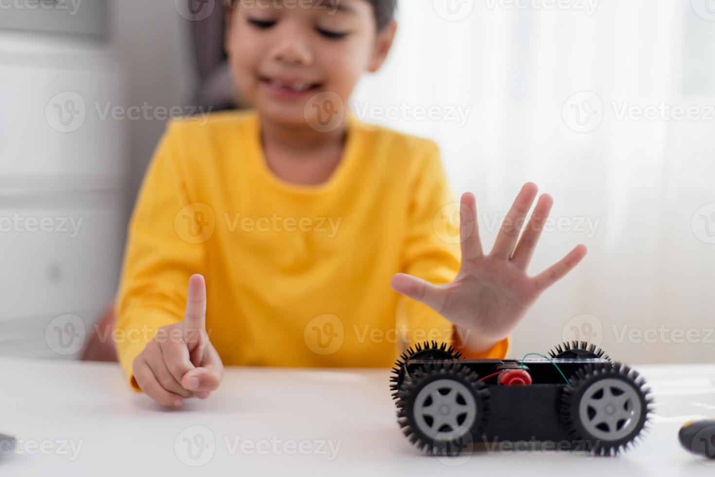 Asia students learn at home in coding robot cars and electronic board cables in STEM, STEAM, mathematics engineering science technology computer code in robotics for kids concept. photo