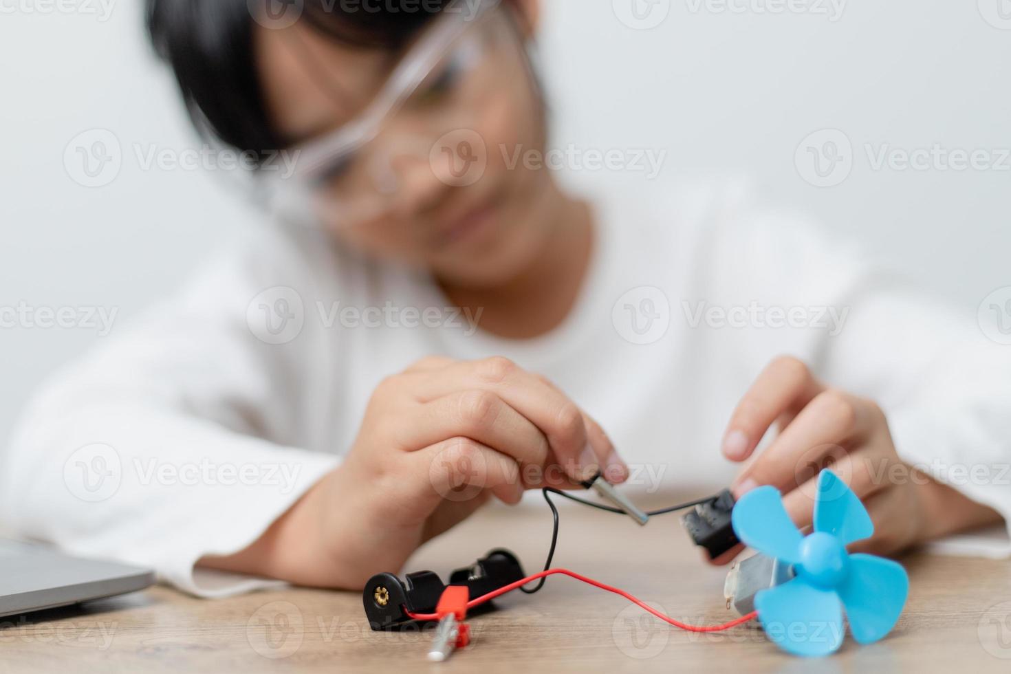 Asia students learn at home in coding robot cars and electronic board cables in STEM, STEAM, mathematics engineering science technology computer code in robotics for kids concept. photo