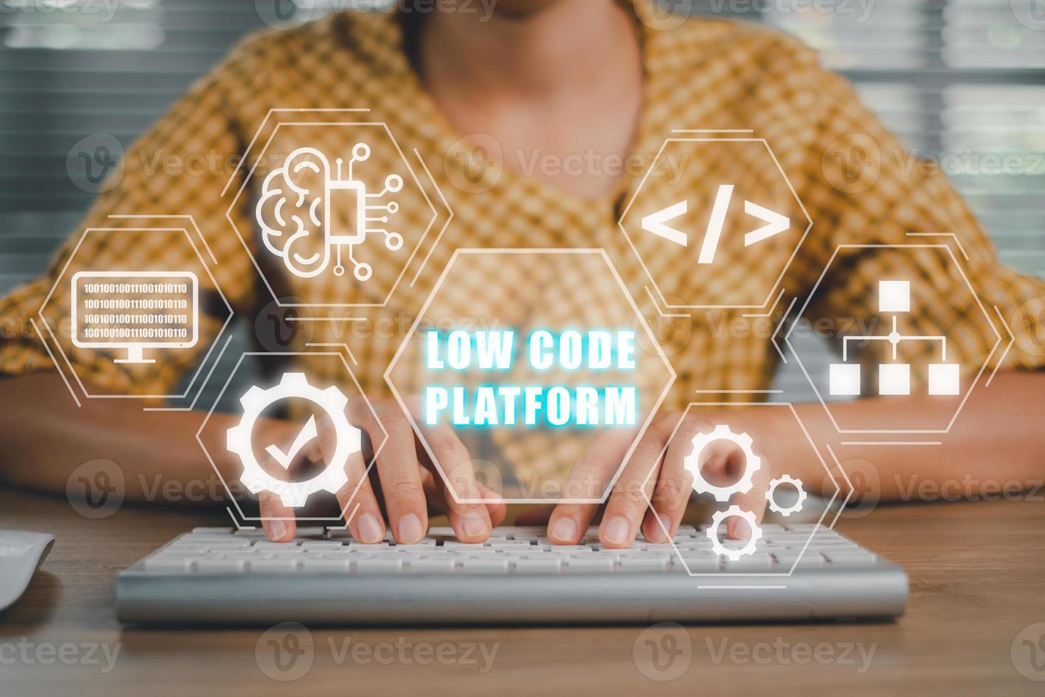 Low Code software development platform technology concept, Woman hand typing on keyboard computer with Low Code software development platform icon on virtual screen. photo