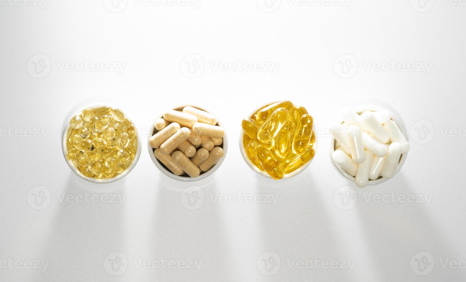 Food supplement oil filled fish oil, vitamin D, omega 3, omega 6, vitamin A, vitamin E, flaxseed oil. photo