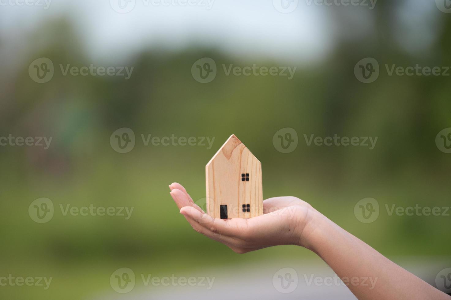 new home concept - young family with dream house scale model in hands photo