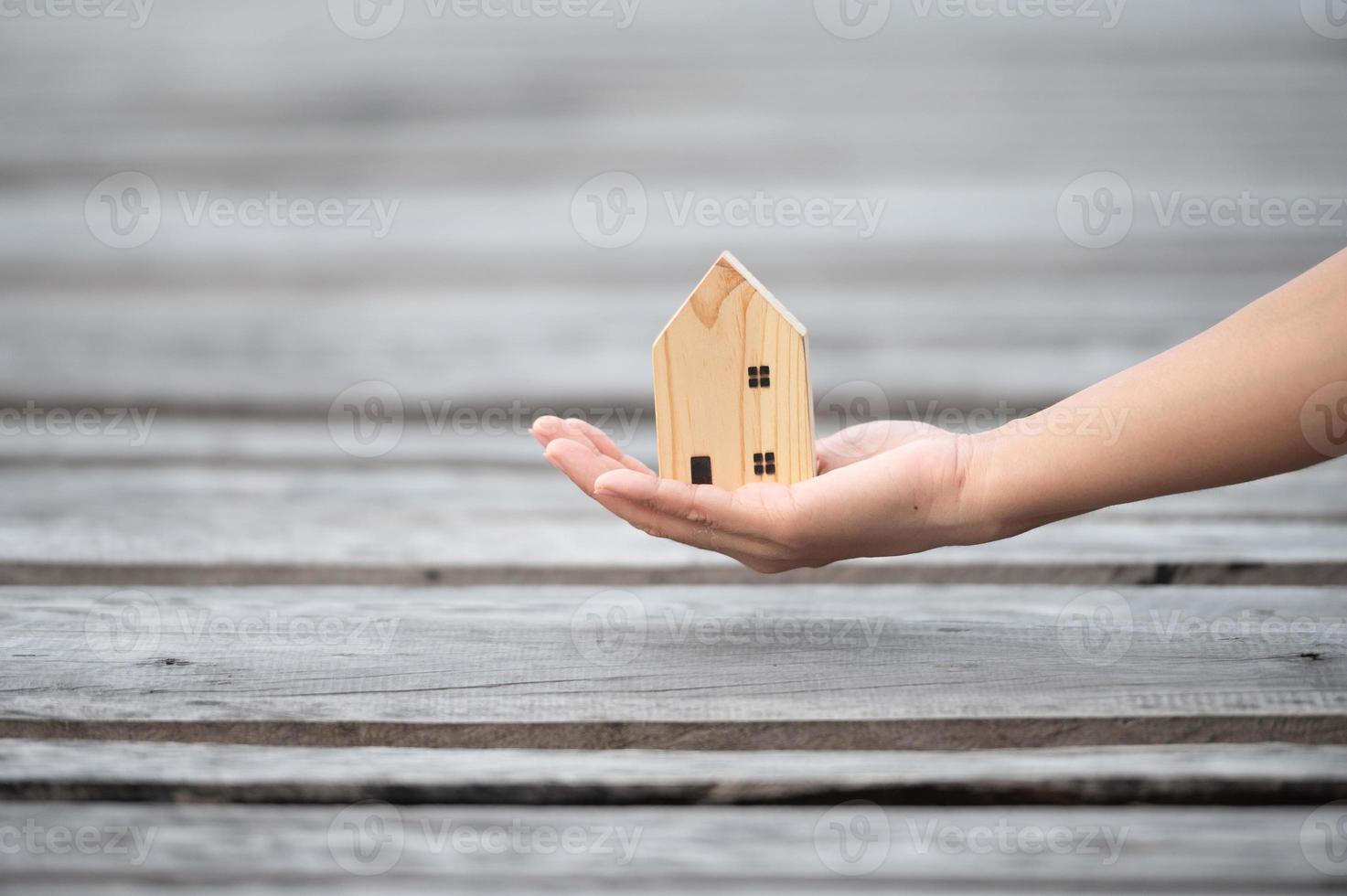 new home concept - young family with dream house scale model in hands photo