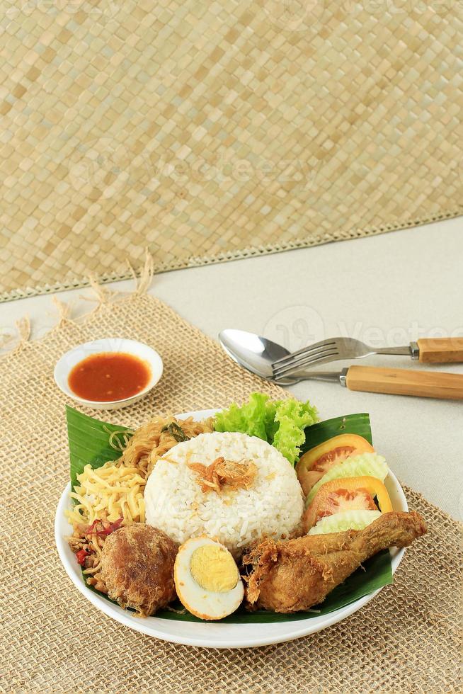 Nasi Uduk or Nasi Lemak, Steamed Rice with Various Side Dish. photo
