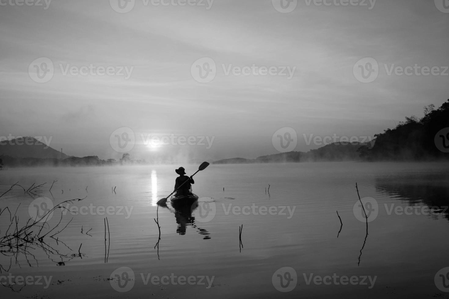 Women on kayak rows in the reservoir during the sunrise, Harirak forest park Huai Nam Man reservoir Loei Thailand 21 Jan 2023 photo