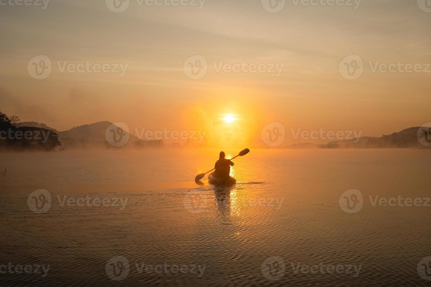 Women on kayak rows in the reservoir during the sunrise, Harirak forest park Huai Nam Man reservoir Loei Thailand 21 Jan 2023 photo