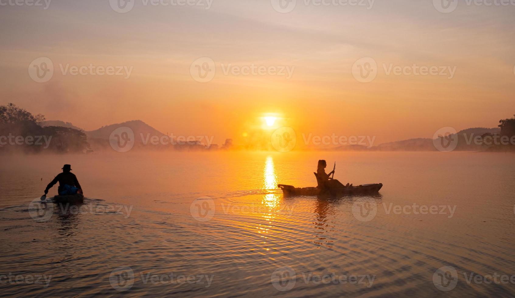 Women on kayak rows in the reservoir during the sunrise, Harirak forest park Huai Nam Man reservoir Loei Thailand 21 Jan 2023 photo