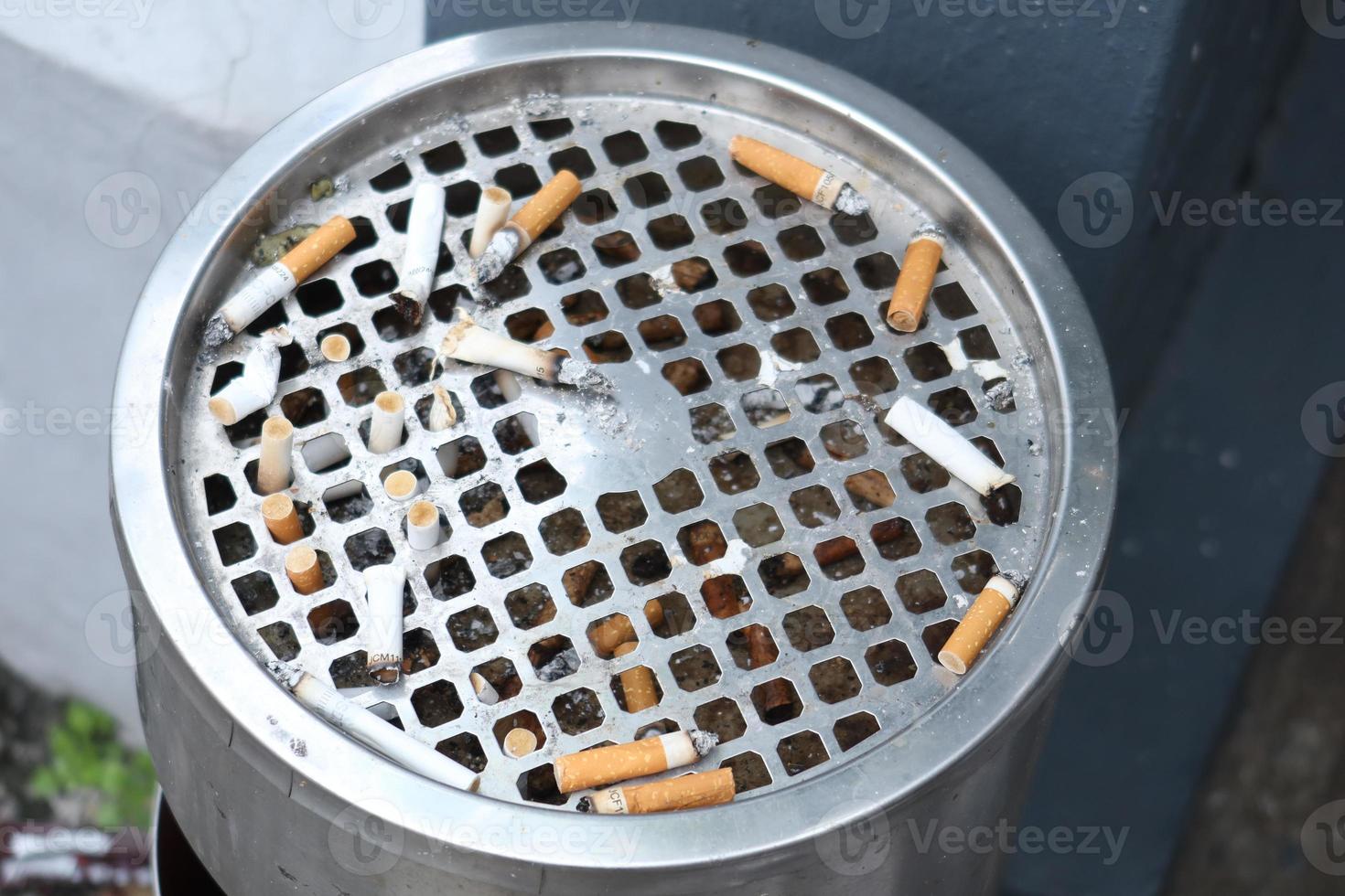 close up of burning cigarette on dark background photo