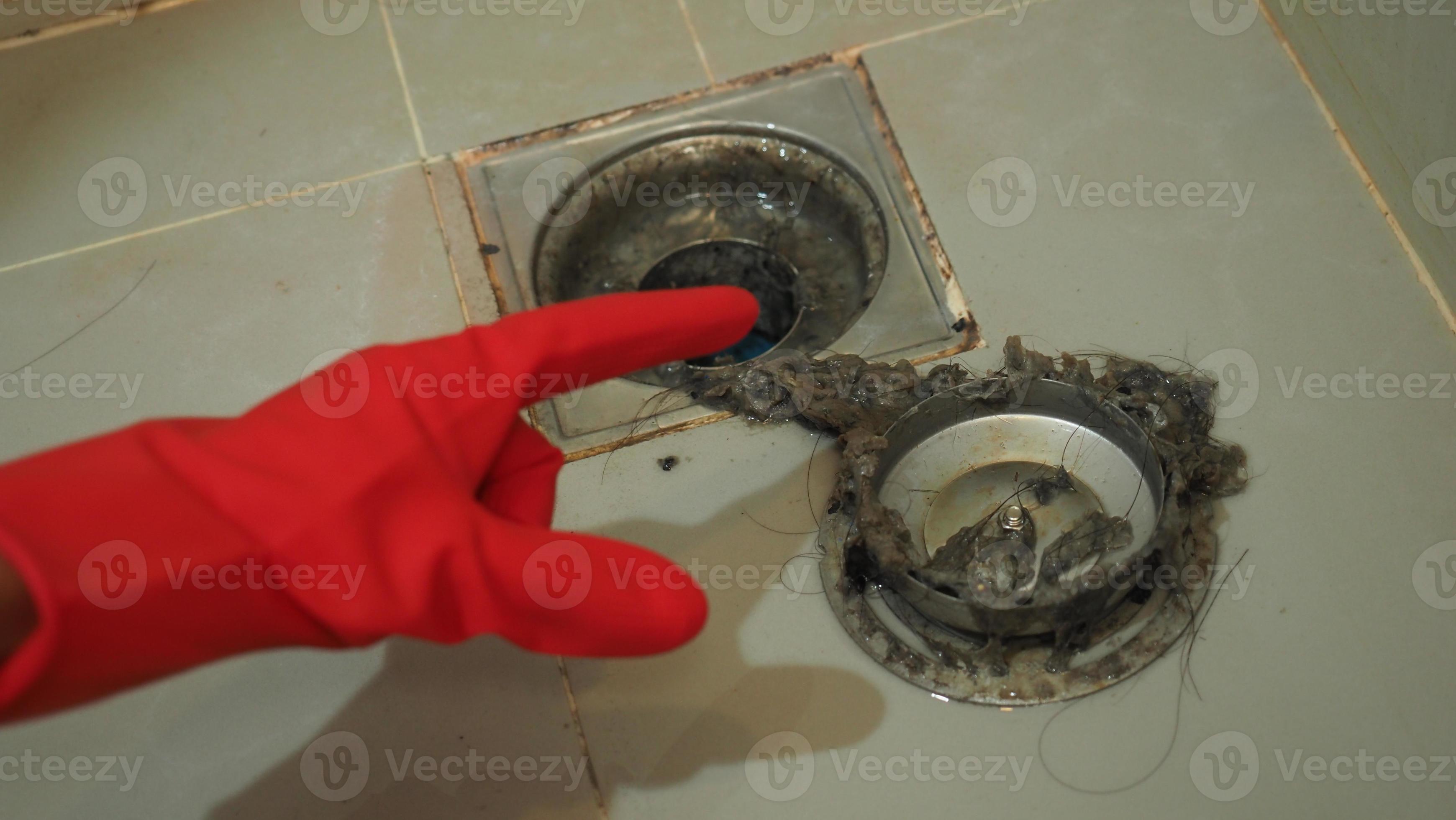 Drain cleaning. Clogged and dirty sewer pipes floor drain. Full of hair