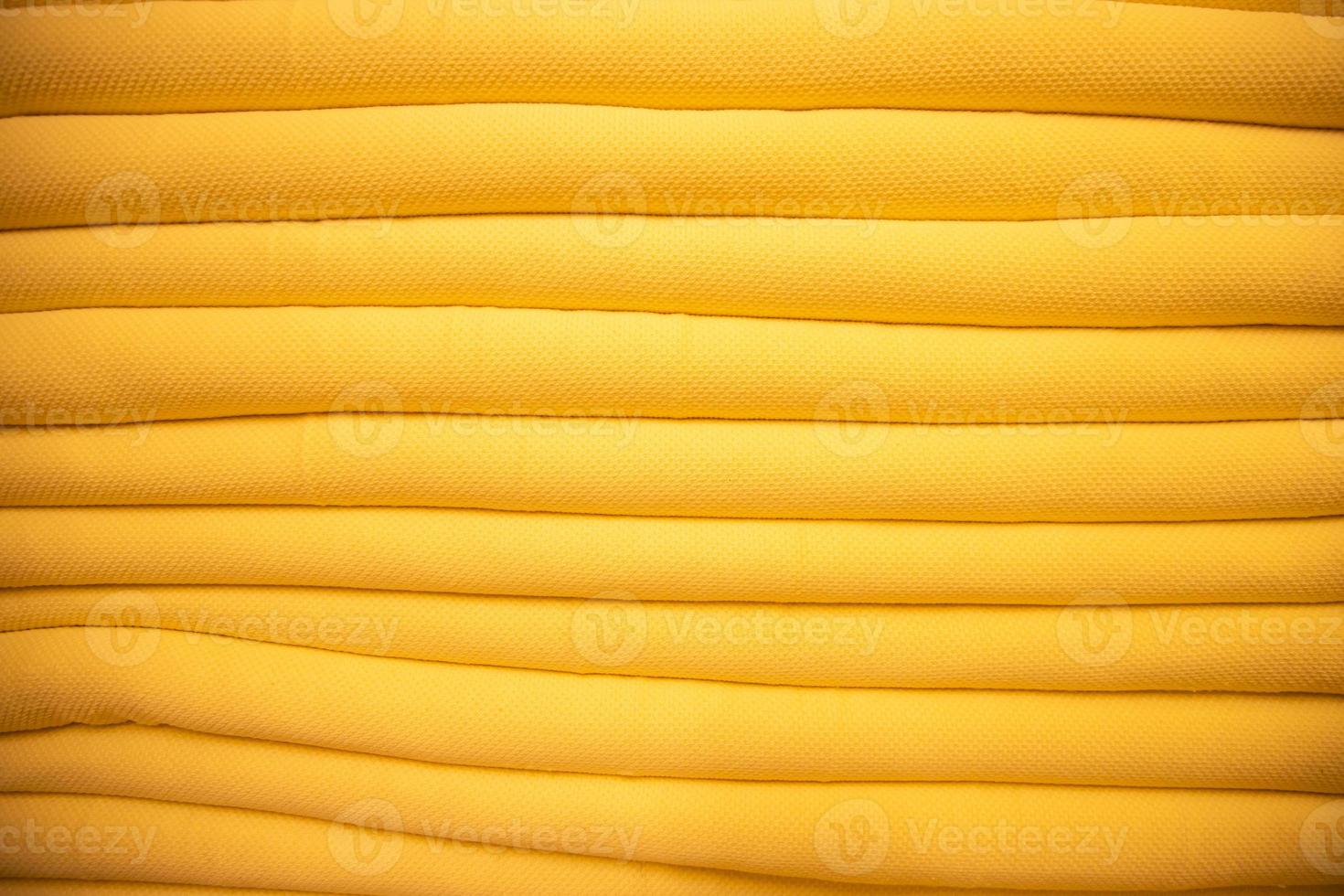 folded stacked Yellow sherpa fabric backdrop pattern can be used as a textured background photo