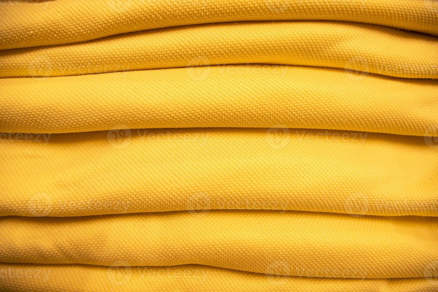 folded stacked Yellow sherpa fabric backdrop pattern can be used as a textured background photo