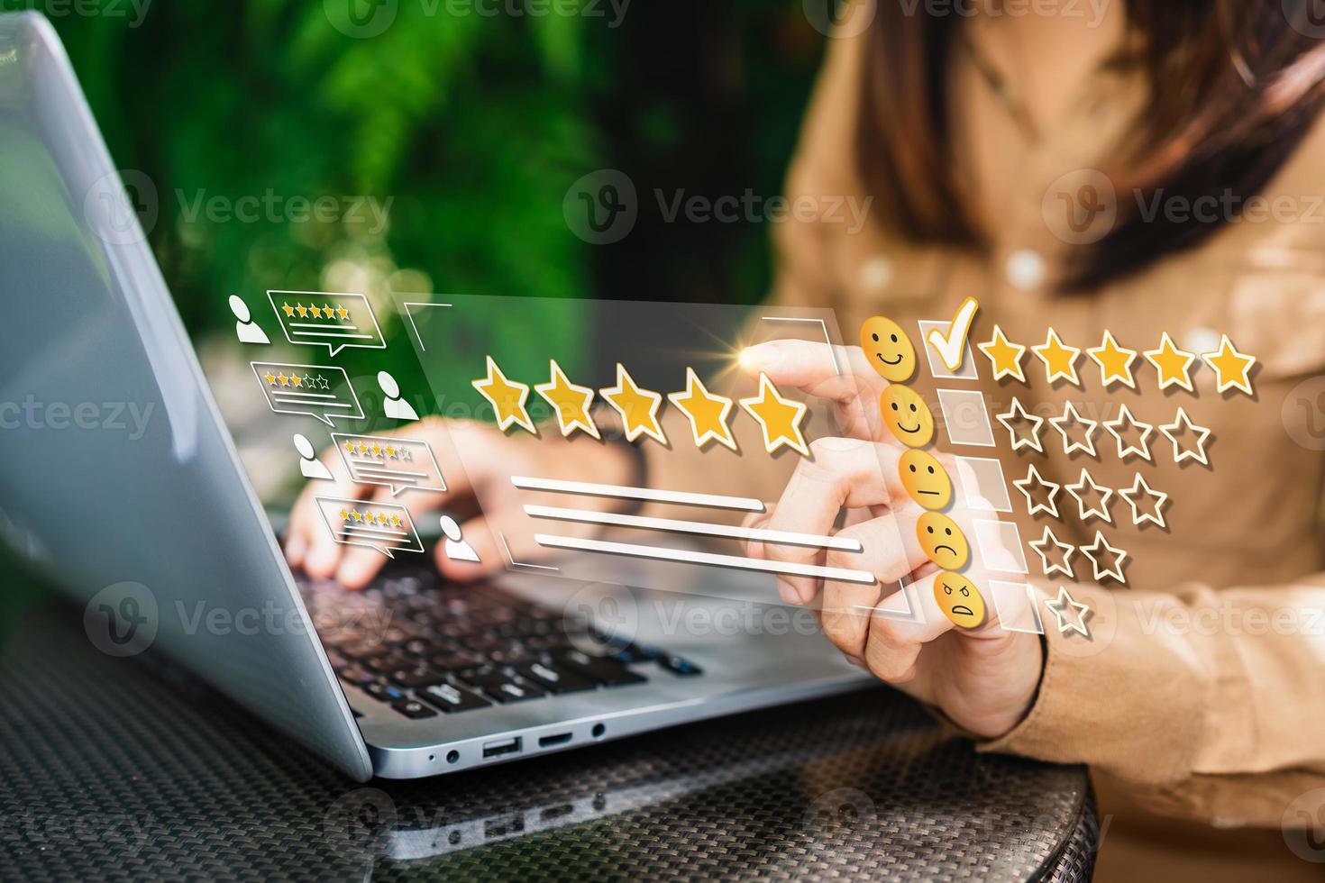 Young woman traveler using laptop to give a five-star satisfaction rating of the food and drinks at restaurant on social media, Travel lifestyle concept photo