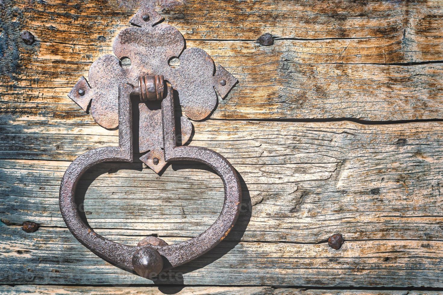 An old door with an iron handle photo