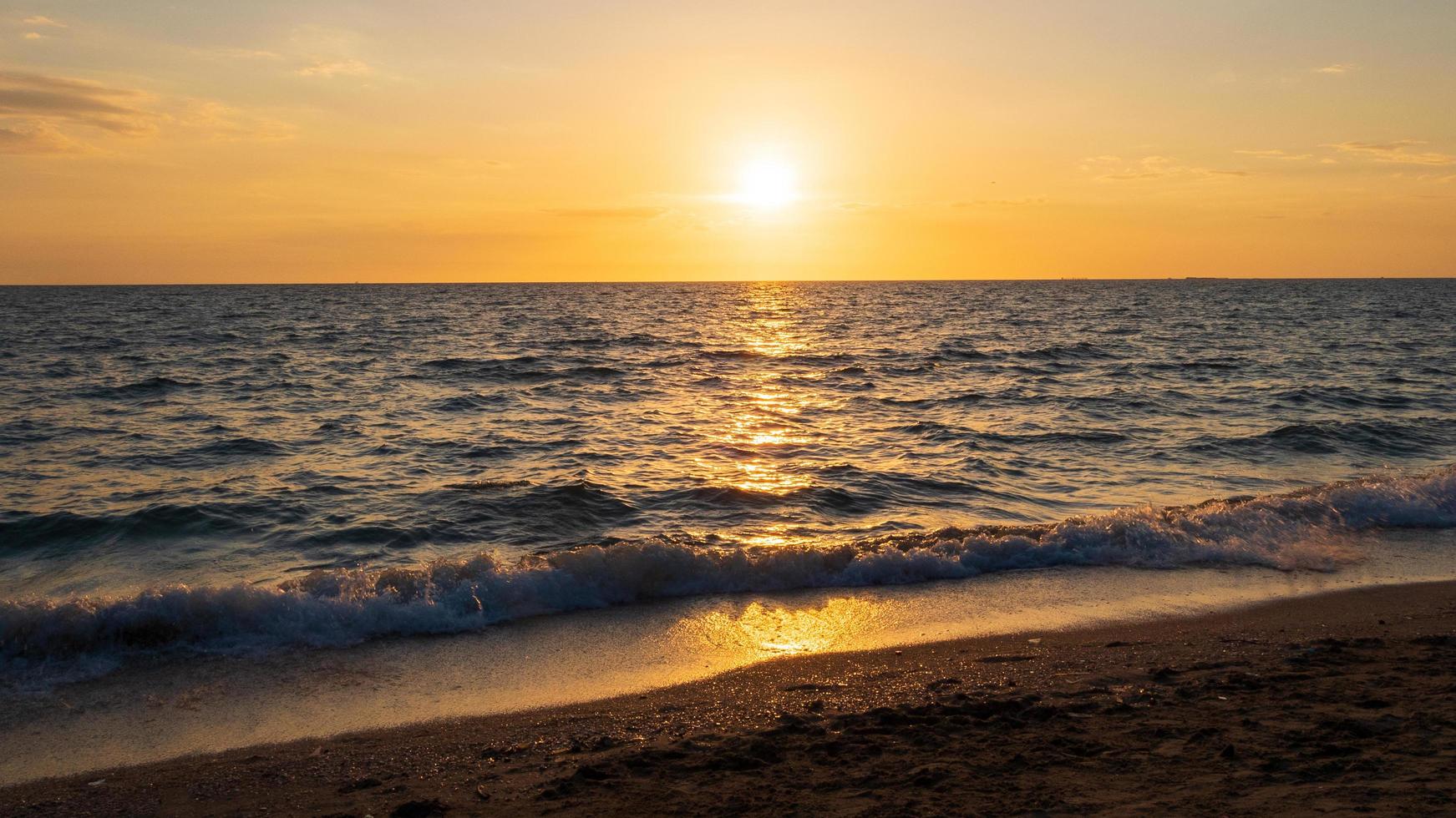 Front viewpoint landscape travel summer sea wind wave cool on holiday calm sea coastal area big sun set sky light orange golden Nature tropical Beautiful evening hours day At Bang san Beach Thailand. photo