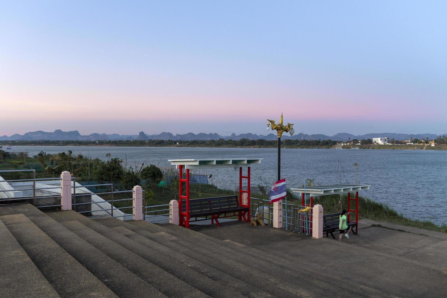 Concrete stairs on the banks of the Mekong River.Exercise area on the banks of the Mekong River.The view of the Lao coastline with complex mountains.The evening view of the Mekong River. photo