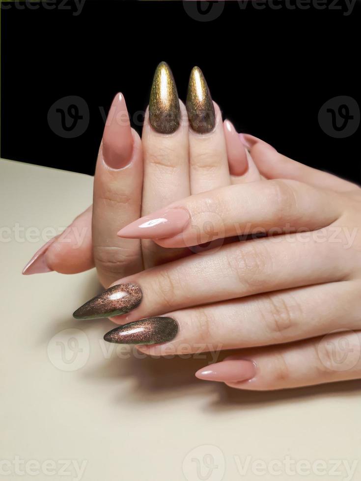 Acrylic nail extension, manicure, nail correction, hands in the foreground. Reflective design. photo