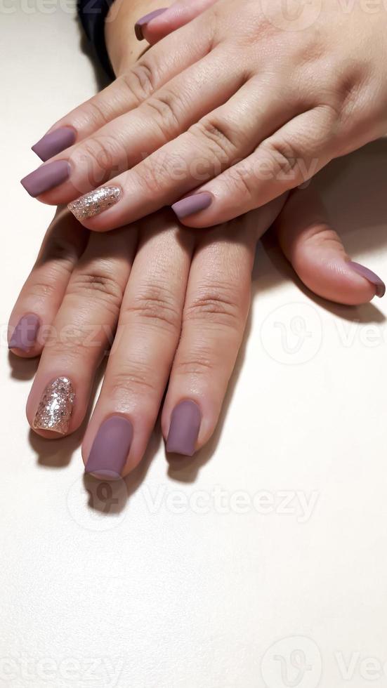 Acrylic nail extension, manicure, nail correction, hands in the foreground. Reflective design. photo